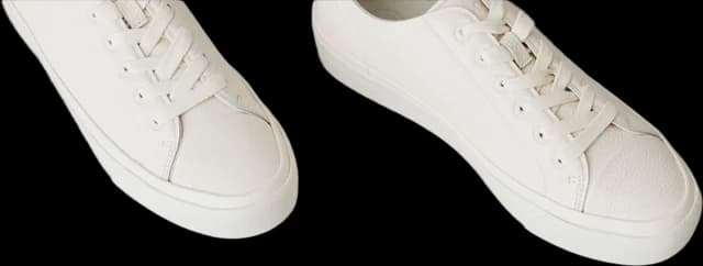 White sneakers on a white floor, background removed